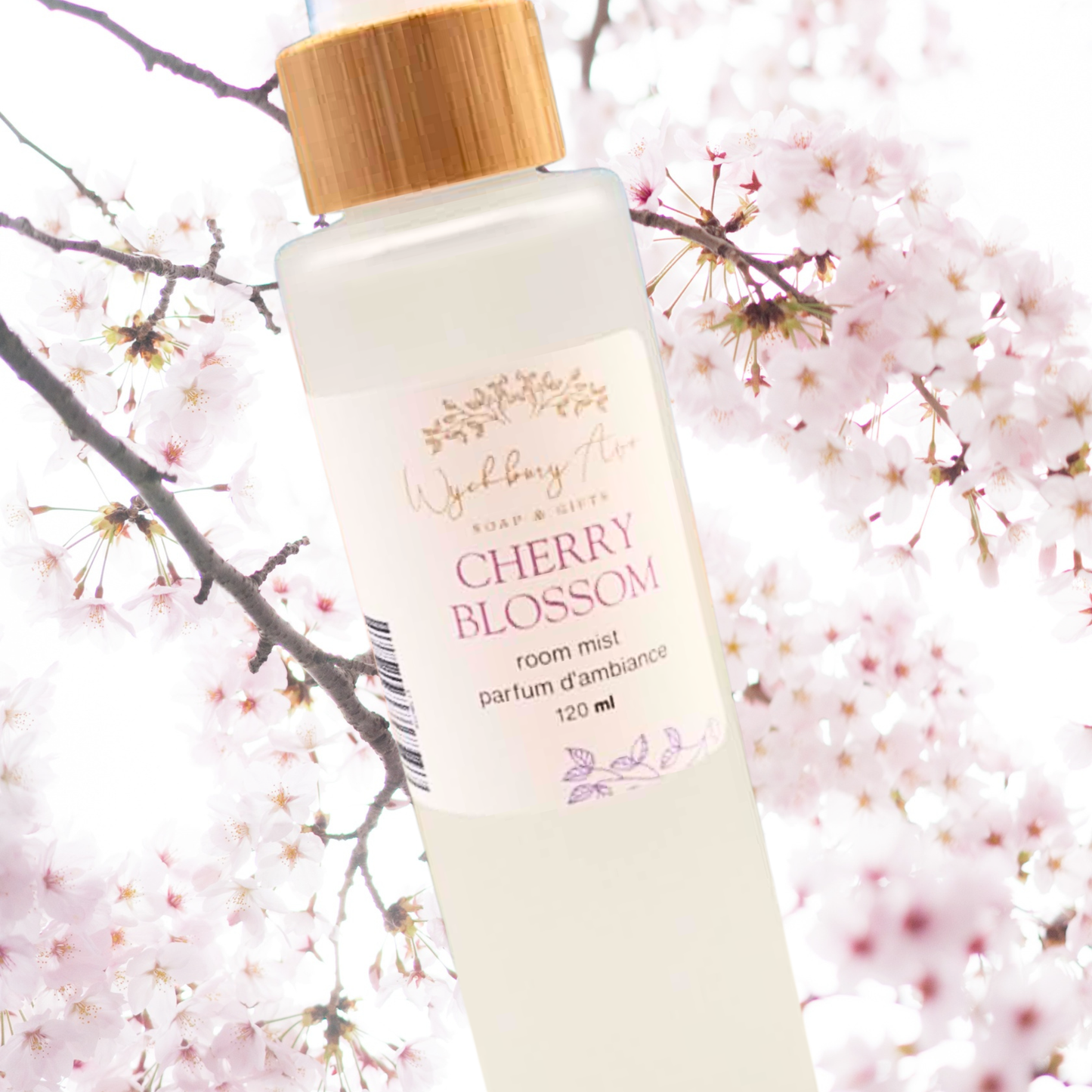 Cherry blossom room mist bottle with a bamboo cap against a cherry blossom background