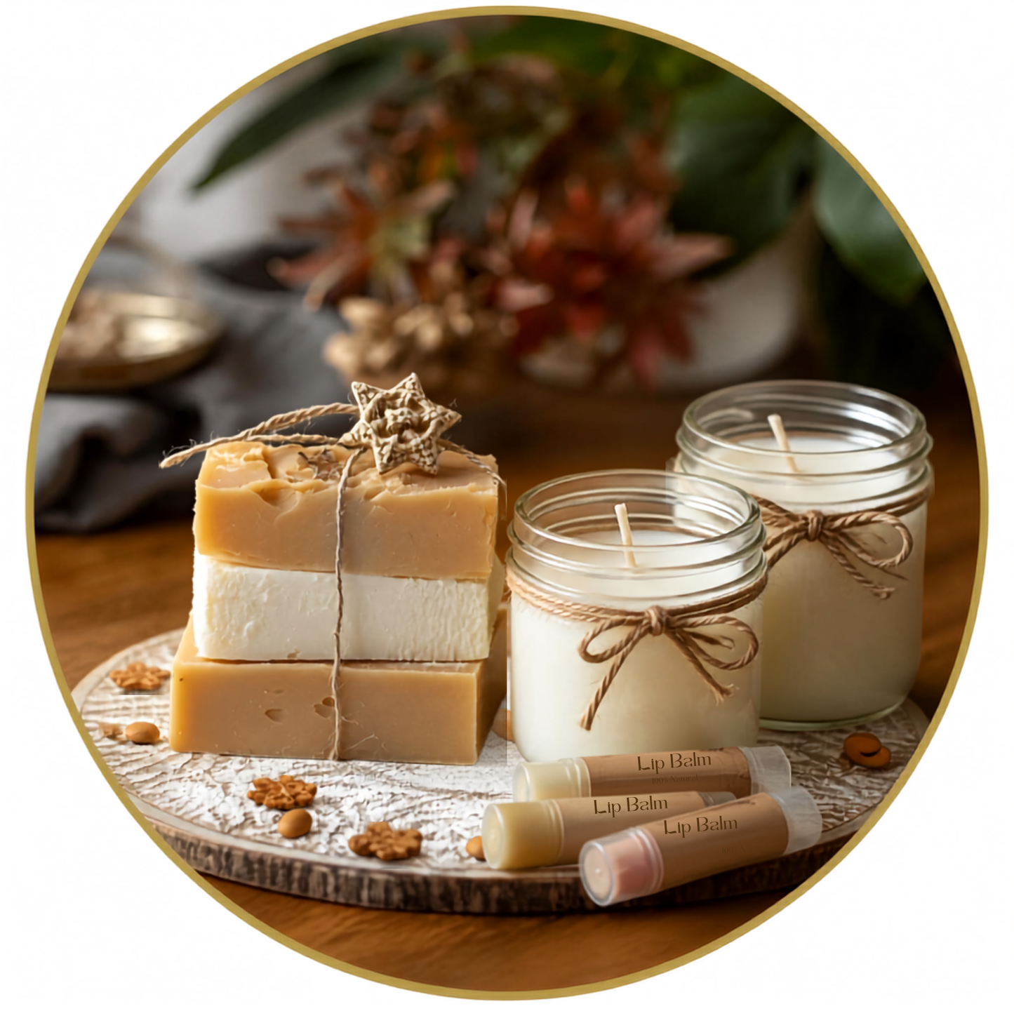 A styled product display of handmade soaps and lip balm tubes arranged on a decorative tray with two glass jar candles, set on a wooden surface with a blurred natural background inside a circular frame.