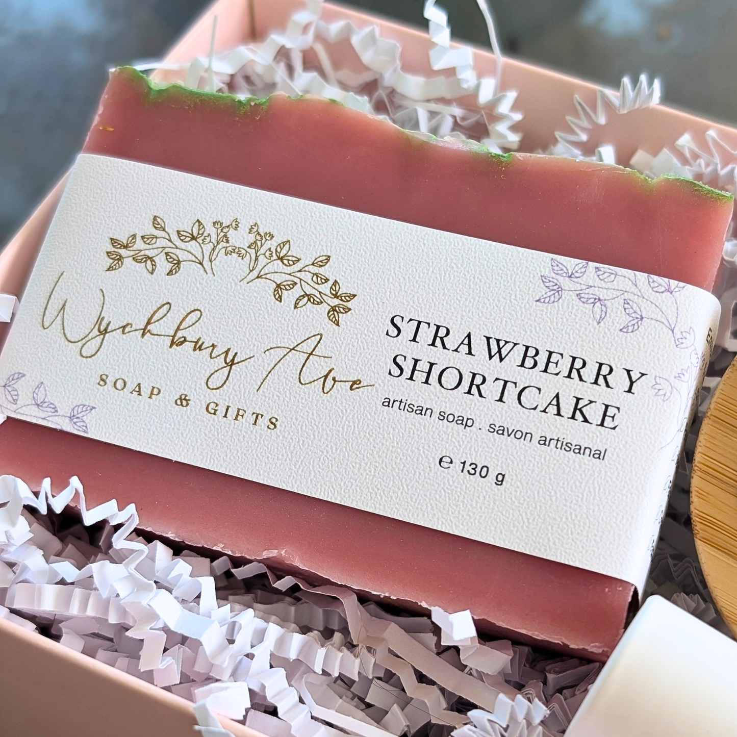 Bar of strawberry shortcake soap with a visible label on a textured surface