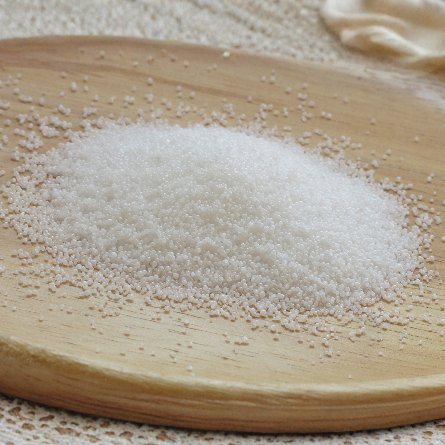 Stearic acid pellets on a wooden surface