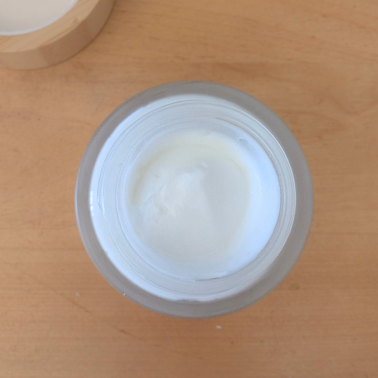 Jar of cream on a wooden surface