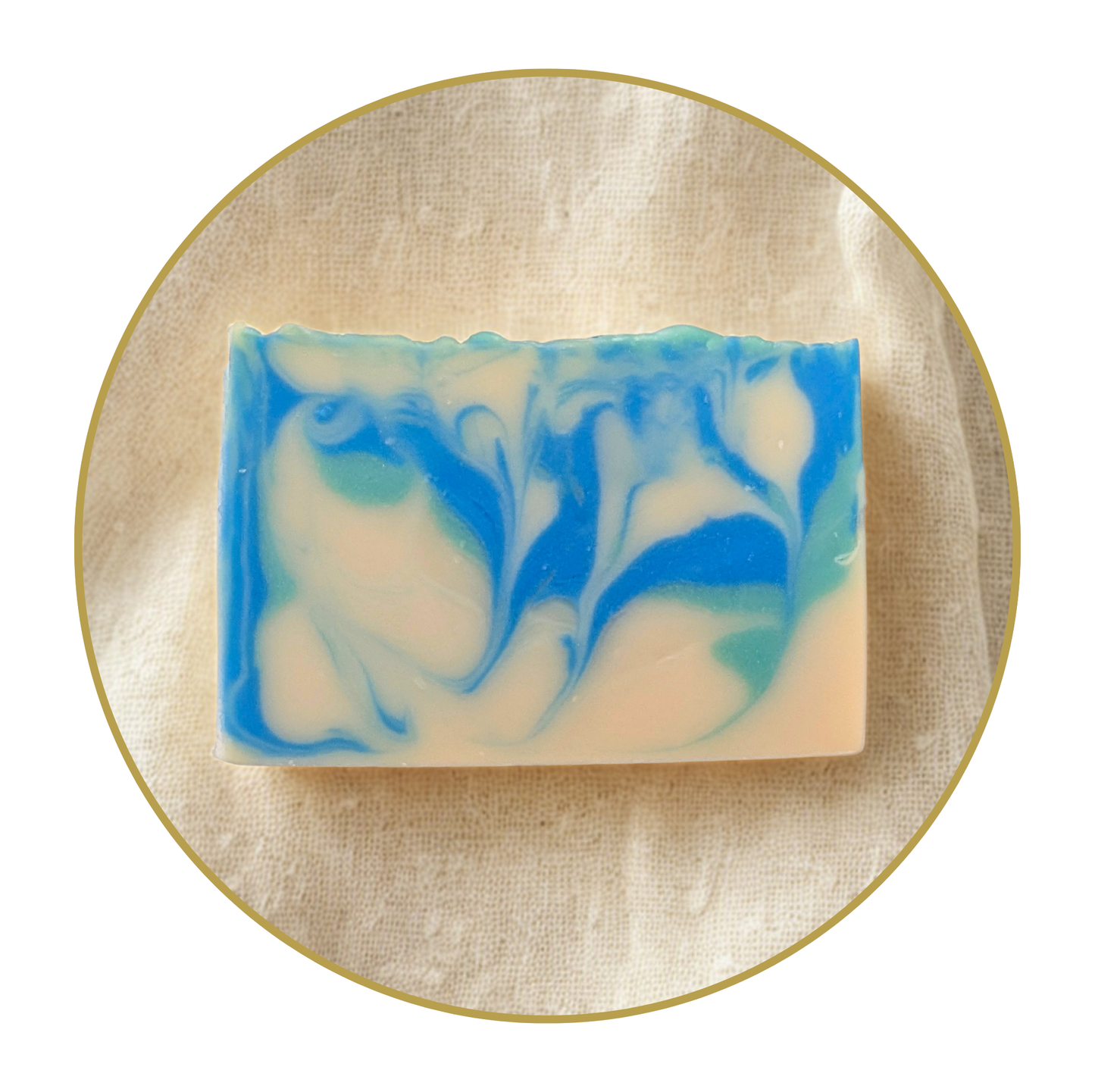 creamy white bar soap with blue and emerald green swirls