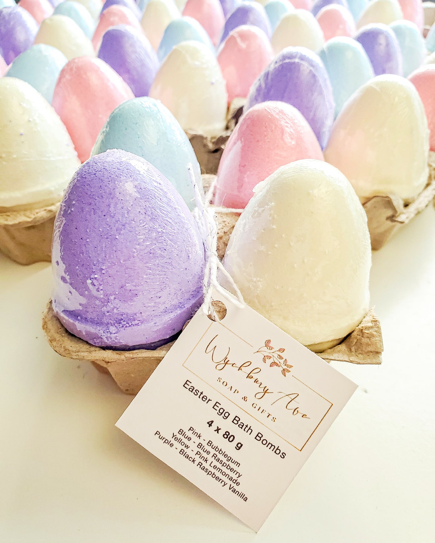 Colourful Easter egg bath bombs styled with spring florals for Easter gifting