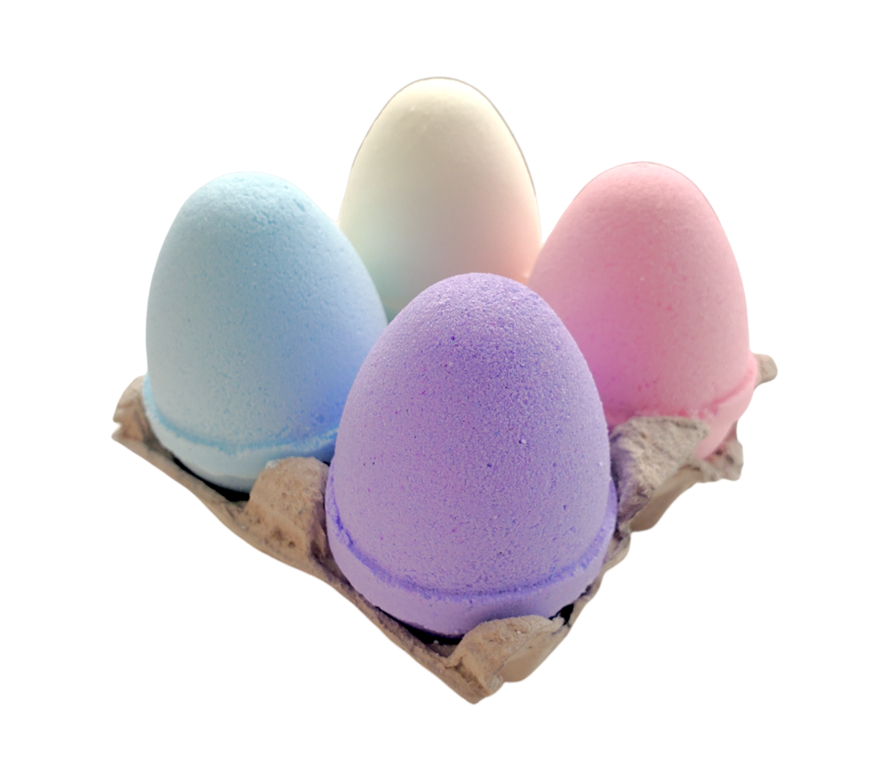 Easter egg bath bombs in purple, pink, blue, and yellow in an egg carton
