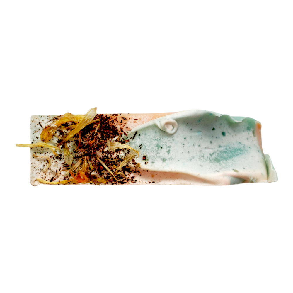 calendula and vanilla powder on top of hibiscus ylang ylang soap