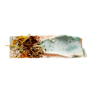 calendula and vanilla powder on top of hibiscus ylang ylang soap