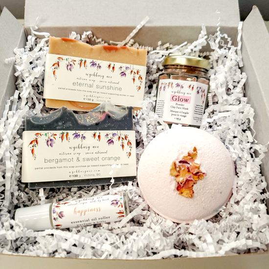 Birthday gift set with two handmade soaps, a bath bomb, face mask, and essential oil roller