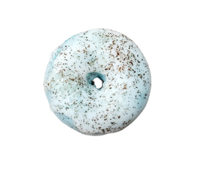 Rootbeer mini donut bath bomb with cocoa butter icing and vanilla bean specks